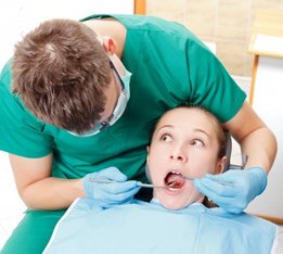 dentist doing an oral exam on an anxious patient